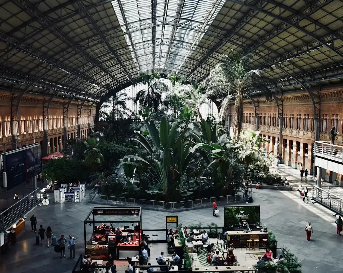 Jardín tropical del interior de la estación de Madrid Atocha con viajeros
