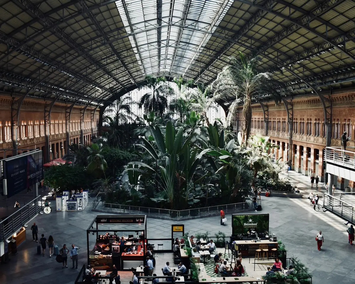 Jardín tropical del interior de la estación de Madrid Atocha con viajeros